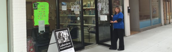 woman holding door open to vet clinic