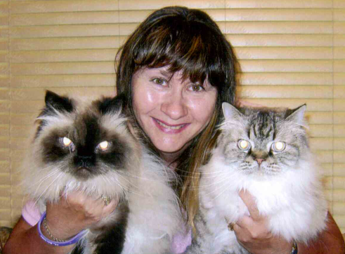 woman holding two cats