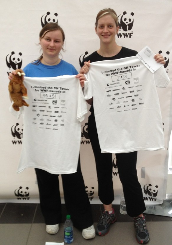 Woman holding tshirts for WWF CN Tower Climb