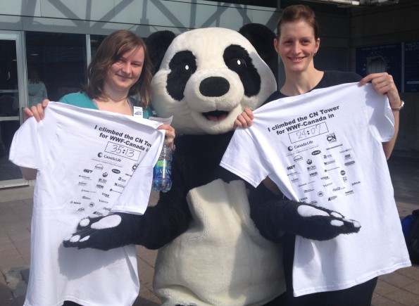 two woman posing picture with tshirts and giant panda