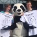 two woman posing picture with tshirts and giant panda